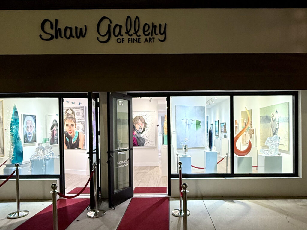 Artist Leslie Berenson in the window of Shaw Gallery on 5th Fifth Avenue South in Naples, Florida displaying her boat art and other fine art.