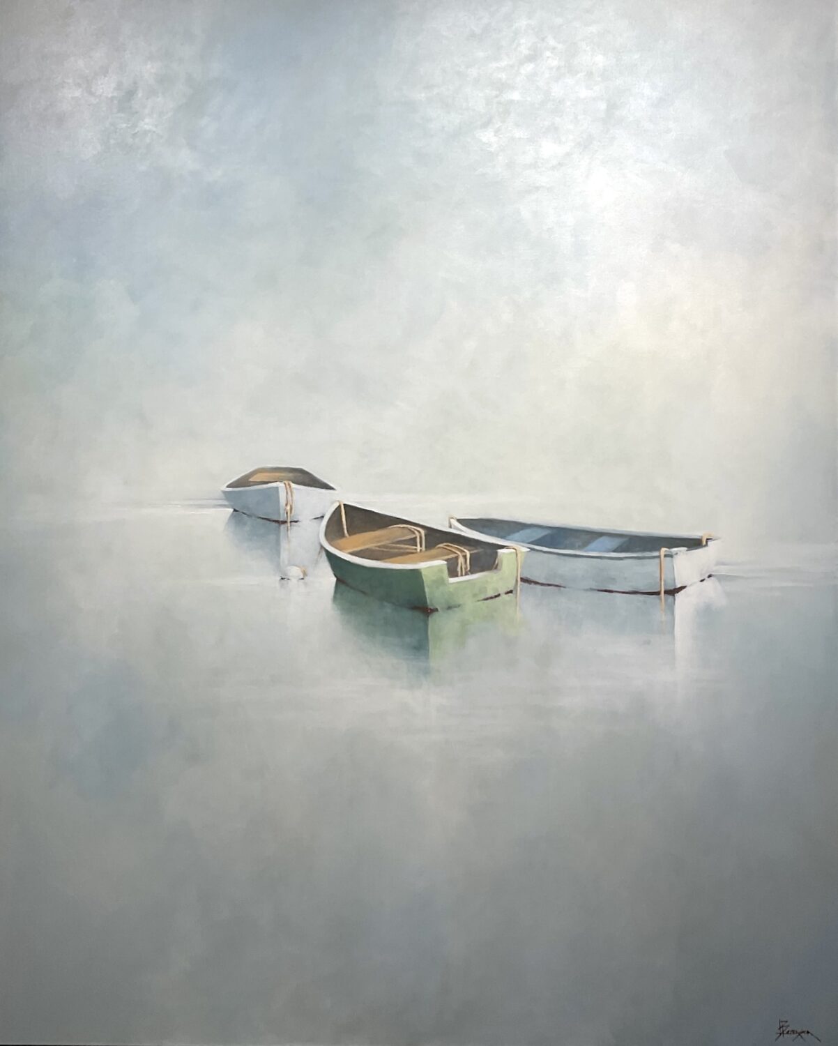 In Harmony Three small, empty rowboats float quietly on calm, misty water. The boats, painted in muted green, blue, and beige, are softly reflected in the water. The background is hazy, blending gently into the sky, creating a tranquil, serene atmosphere.